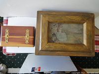 Both wood storage boxes side by side on a white surface showing size difference and overall appearance.