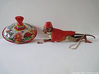 Set showing both the spinning top and mechanical climbing monkey side by side on white background.