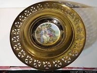 Top view of the plate showing the brass perforated outer rim and painted center artwork