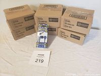 Six sealed cases containing Wicked Audio Brawl Deep Sea ear buds with one individual boxed ear bud shown in front for display.