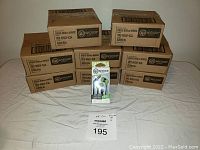 Eight sealed retail cardboard cases containing Wicked Audio Drive 600cc earbuds in green, stacked in two rows.