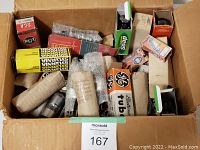 Top view of cardboard box containing various vacuum tubes in original boxes and bubble wrap