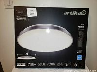 Front view of the sealed box, showing Artika Europa 21-inch LED ceiling light flush mount with remote control image and features.