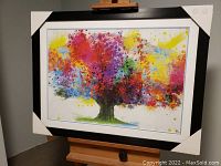 Front view of framed and matted Colour Bursting Tree by Dean Russo with cardboard protections on corners