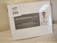 New white Gluckstein Home double fitted sheet in original packaging with label and branding visible.
