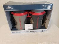 Photo of the boxed set showing two High Sierra branded insulated water bottle jugs with red lids and gray bodies.