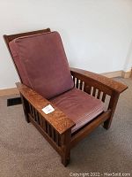 Front perspective of oak Morris chair with pink velvet cushions