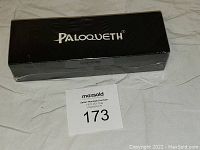 Black rectangular box with Paloqueth branding, sealed with minor packaging damage visible.
