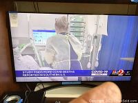 TV powered on displaying news broadcast