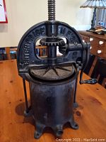 Side view showing the full apparatus with handle, frame, and hopper.