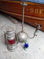 Full view of the three lanterns: vintage railway lantern with red glass, Coleman gas lantern, small cobalt glass ice skating lantern.