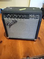 Front view of small Fender Bullet amp showing control panel, knobs, and Fender branded grille