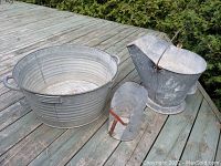 Photo showing the three galvanized items on wooden flooring: wash tub, coal bucket with handle, and small scoop