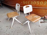 Front view of two vintage Brunswick toddler chairs with wooden seats and backs, white metal legs, placed side by side showing condition and details.