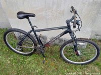 Full side view of the Norco Mountaineer mountain bike showing frame, tires, seat, and pedals.