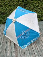 Full view of vintage patio umbrella showing blue and white panel design with Player's Racing Team logos and 'Player's' text.