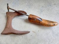 Top view of wooden shoe stretcher and metal shoe anvil showing overall shape and condition.