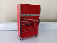 Front and side view of the red Snap On radio shaped like a tool chest with chrome trim and wheels, closed drawers visible.