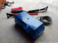 Blue 15-inch double reflector light bar with magnet mount, power cord, and red-handled snow brushes with ice scrapers