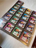 Twenty boxed sets of Anthony Robbins 2-CD audio programs, neatly arranged on a flat surface.