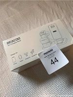 Box front showing Beacoo brand 3 in 1 charging stand compatible with iPhone, Apple Watch, AirPods, AirPods Pro