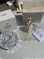 Clear crystal candle holder by Igloo, Kosta Boda box visible, plastic wrapping of other items