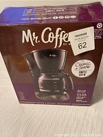 Box front view showing the Mr. Coffee branding, product image, and description highlighting 12 cup capacity and classic taste.