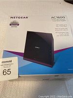 Photo of the original retail box of the Netgear AC1600 Smart Wi-Fi Router featuring brand, model, and key specifications.