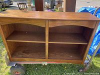 Front view of wooden bookcase showing two shelves and four compartments