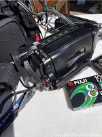 Sony 8mm camcorder on table with Fuji 8mm video tape and power cables