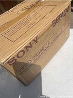 New sealed Sony Betacam video cassette box made of brown cardboard with purple text and branding, marked 'Betacam' and 'Video Cassette'.