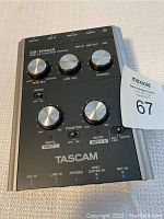 Top view of Tascam US-144mkII audio interface showing control knobs and labels.