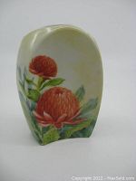 Front view of flower vase showing hand painted bright red flowers with green leaves