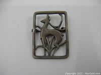 Front view of vintage Danish sterling silver brooch with stylized impala design and rectangular frame.