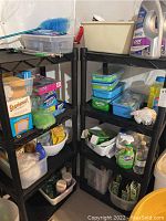 Four-tier black plastic shelving units holding various cleaning and storage items including Clorox spray, Swiffer containers, Ziploc boxes, and other supplies.