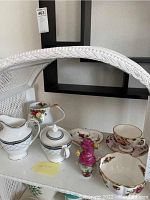 Set of 10 Royal Albert and Royal Doulton china pieces with floral patterns and gold trimming, including bowls, creamers, teacups, saucers, sugar bowl, and a small decorative figurine.