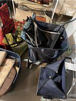 Photo showing multiple wheeled carts with fabric bags in various patterns and colors, demonstrating the type and style of carts in the lot.