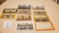 Top-down image showing all 10 stereoscope viewing cards laid out flat, exhibiting various scenes and border colors.