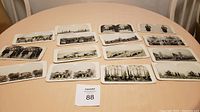Photo of 15 stereoscope World War I viewing cards laid out on a table, showing all cards and their arrangement.