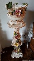 Full view of the vintage Capodimonte floor pedestal with matching vase on top, showing the height and ornate floral design.