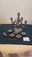 Full candelabra with broken down candle holders and finial displayed