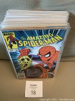 Front view of multiple Amazing Spider-Man comics arranged stacked vertically in protective sleeves showcasing vibrant cover art.