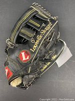Full view of the black Louisville Slugger baseball glove showing brand and wear.