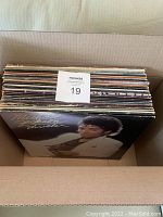 Box filled with vinyl LP records showing top of stack and album jackets