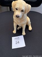 Front and angled front view of the golden retriever pup coin bank made by Wild Wings USA, showing detailed features and size reference with a MaxSold card.