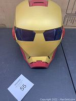 Front view of the red and gold Iron Man helmet with closed visor.