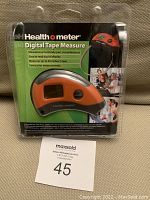 Front package view showing the Health o Meter digital tape measure, branding, and features on card insert.