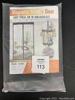 Photo of folded magnetic screen door in clear plastic bag showing product label with text and images describing features of magnetic closure, bug blocking, fresh air flow, fits most patio doors. Screen size marked as 100x210 cm (39x83 inches).