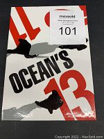 Front view of Oceans 13 card sleeve, white with black and red text, showing minor use wear.