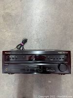 Front view of Pioneer VSX-D458 A/V receiver showing control panel, volume knob, input buttons, headphone jack, and display.
